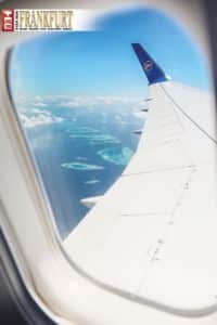Die Inselwelt der Malediven beeindruckt schon durch das Fenster des Condor-Flugzeugs.